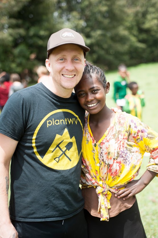 North American partner posing with girl in Ethiopia