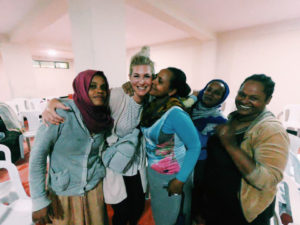 Amy huddled with mothers from a community in Ethiopia.