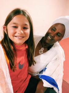 Daughter of the blog's author sitting with a mother in Ethiopia.