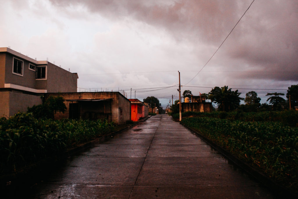 Rural street in Guatemala with storm clouds overhead
