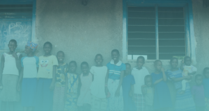 Children in Uganda standing against a wall