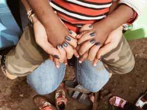 Friends holding hands