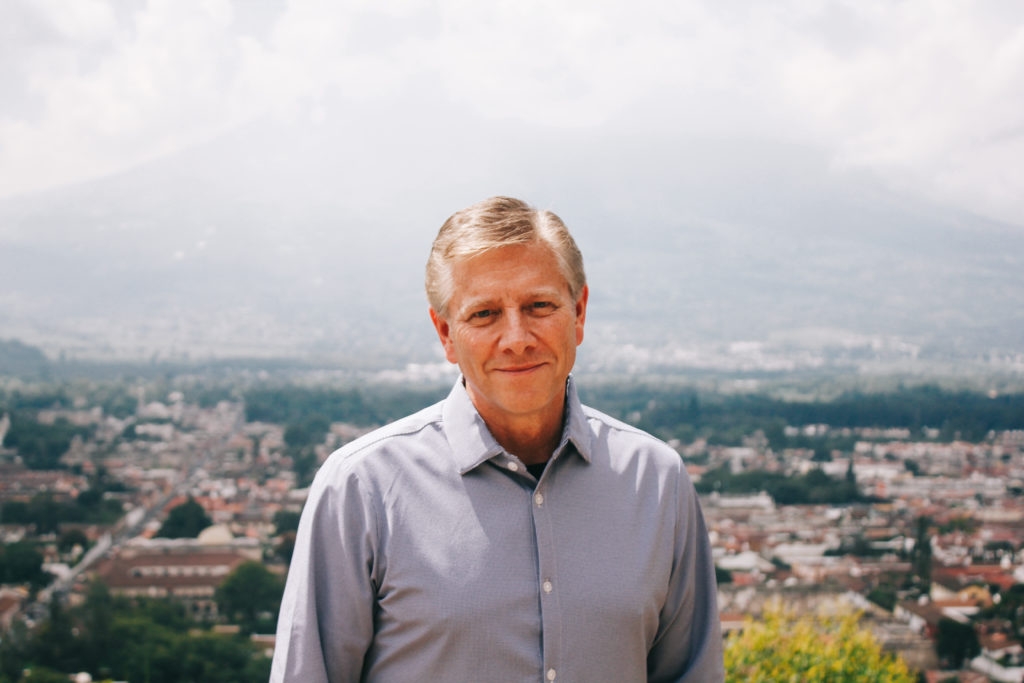 Ken Sparks stands in front of a volcano in Guatemala