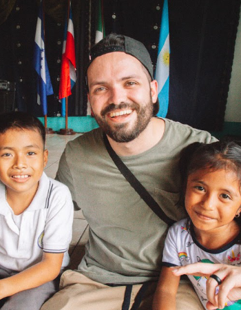 North American man in Guatemala with two Guatemalan children