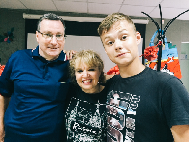 A couple in Russia pose with their sponsored child