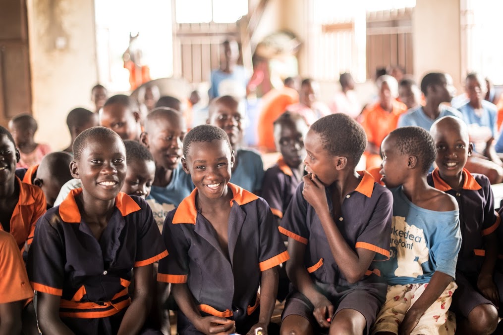 Children in Uganda smile and look into the camera