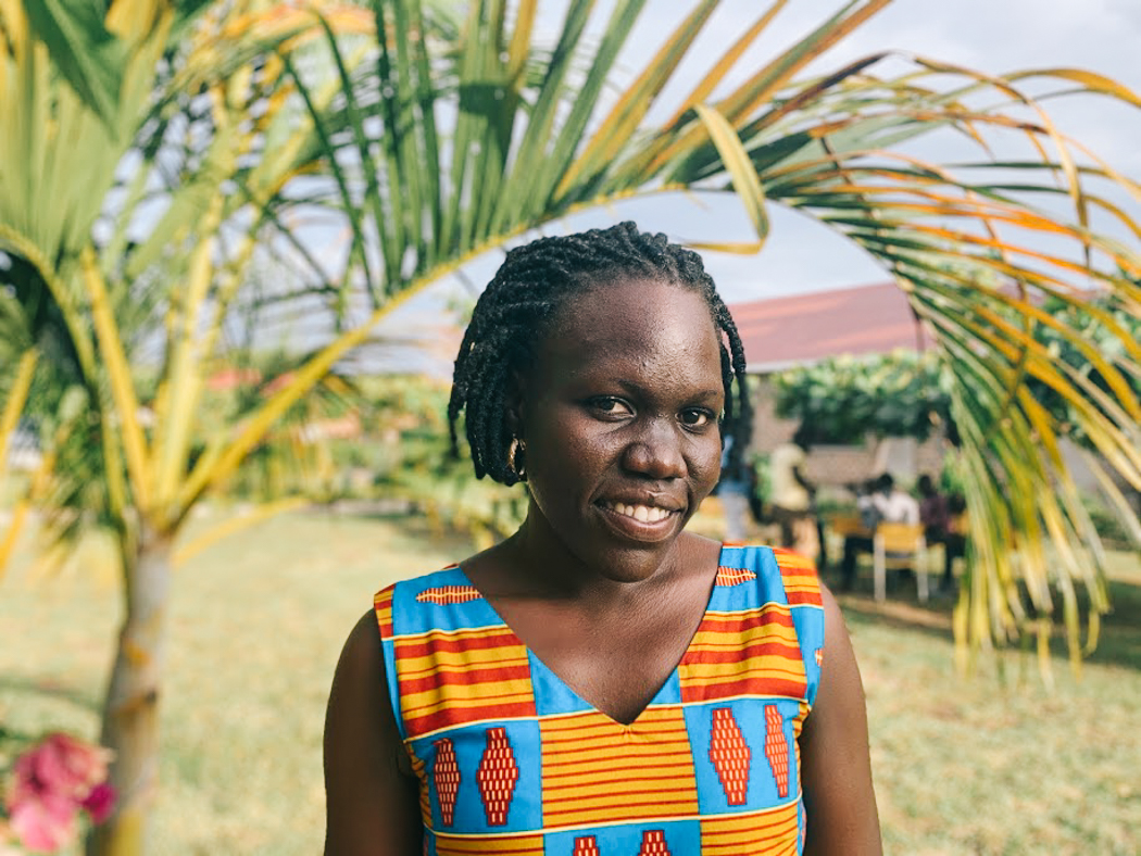 Vicky standing in front of a tree, smiling