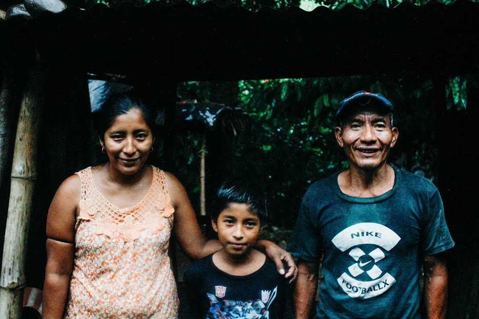 A mother holds her arm around her young son and his grandfather