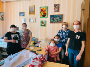 Russians wearing masks they made in a sewing class