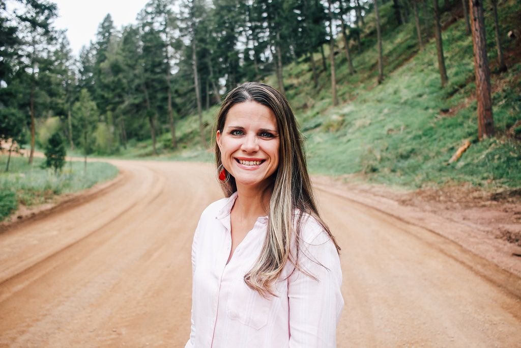 Rachel standing on a forest road