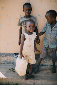 child holding a jerrycan