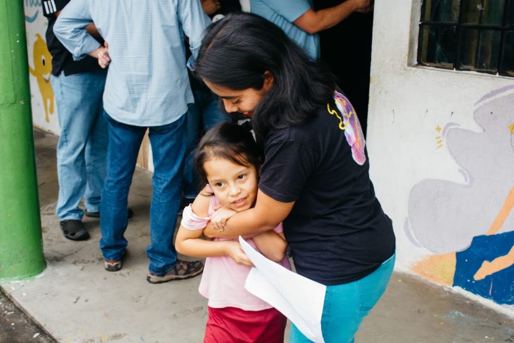 CarePoint leader hugging a child