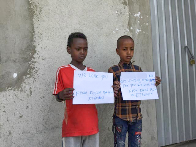 Children holding signs for their HopeChest Friends