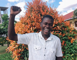 young leader in Uganda with hand in the air