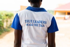 woman wearing a "true leaders walk the talk"