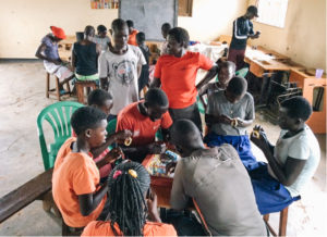 Children in Uganda making crafts