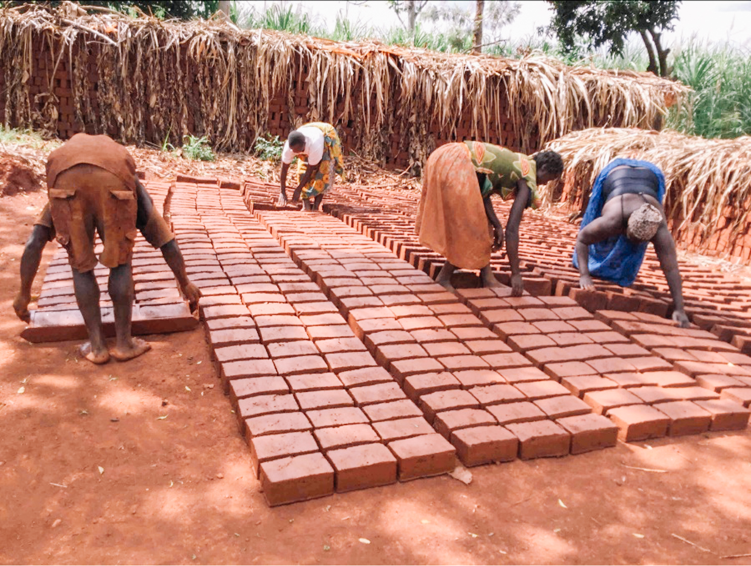 Women in Uganda making bricks
