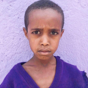 Portrait of Bekah in front of a purple wall