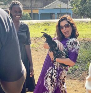 Traveler holding a chicken